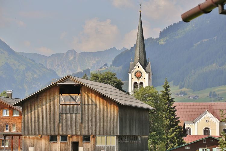 Low angle view of buildings and mountains against sky rietzlern austria 