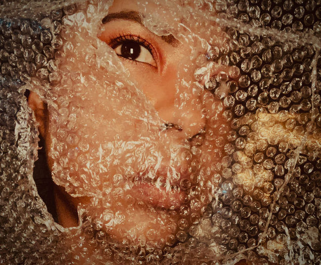 Close-up portrait of woman in bubble wrap