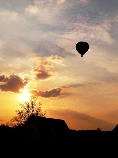 Silhouette hot air balloon against sky during sunset