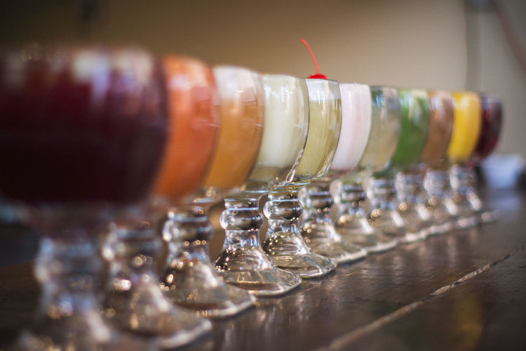 Close-up of colorful drinks arranged on table