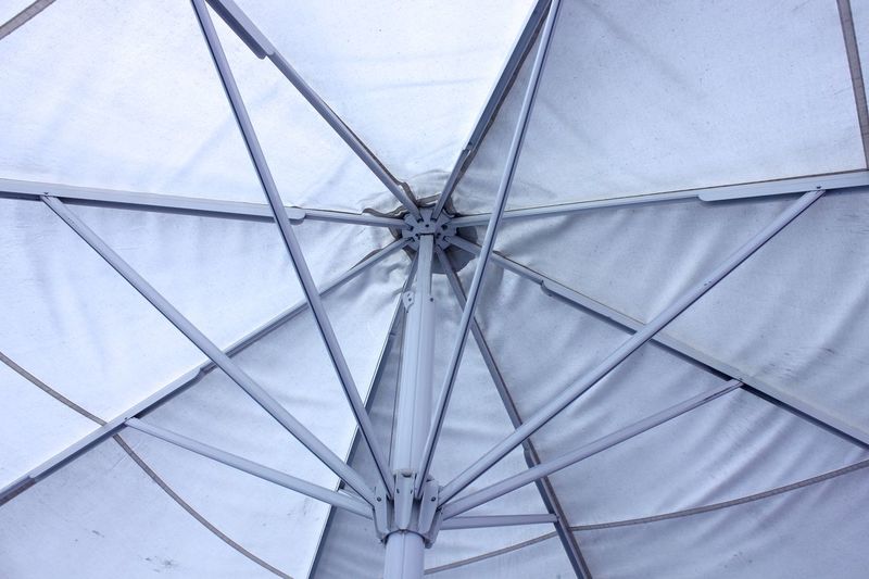 Low angle view of white umbrella 