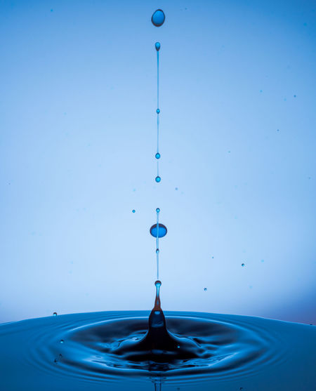 Water splashing against blue background