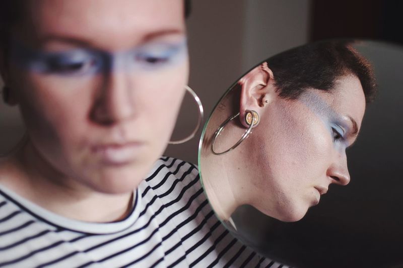 Blue line. Mirror Reflection Mirror Not Your Cliche Two People Mid Adult Men Real People Young Adult Indoors Eyeglasses Young Women Headshot Lifestyles Togetherness Women