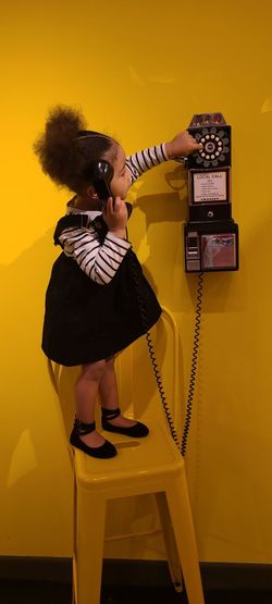 Portrait of child using retro phone