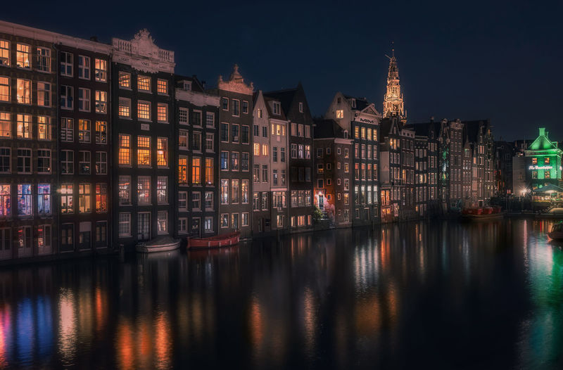 Reflection of buildings in city at night