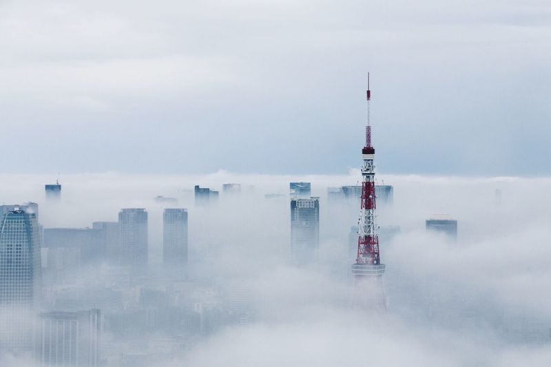Cityscape and tokyo tower covered in clouds