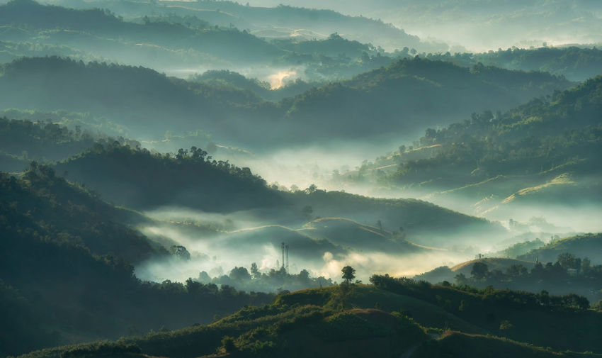 Scenic views of mountains in fog