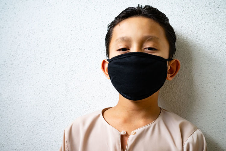 Asian young kids are wearing hygienic reusable face mask to prevent the virus. new normal.