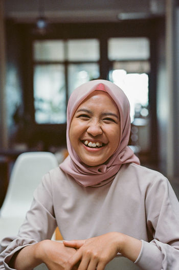 Portrait of smiling young woman in hijab