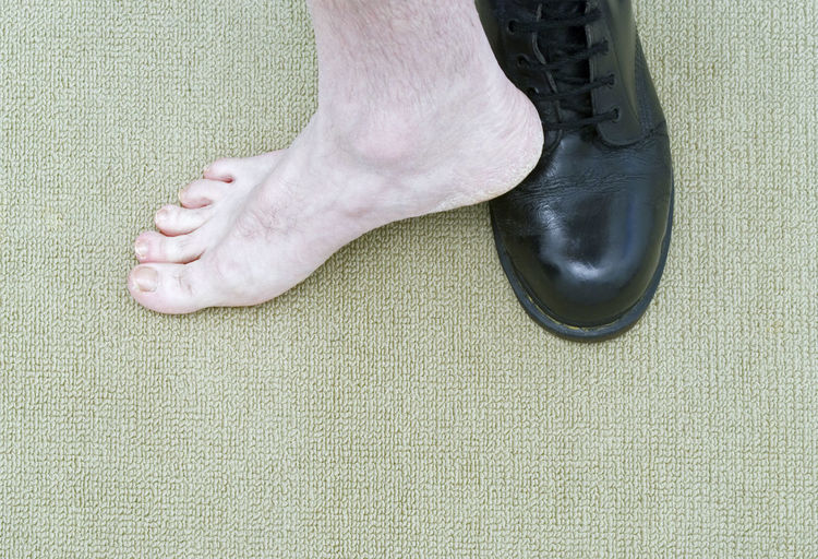 Low section of person legs on carpet
