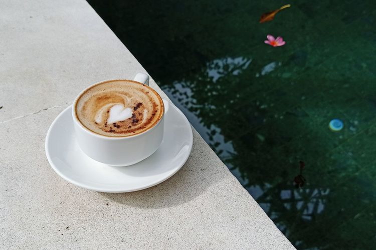High angle view of coffee on pool side