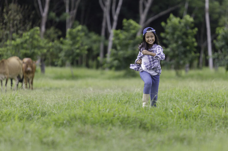 Cute girl playing on grass at park