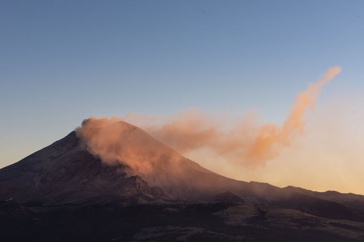 Popocatlepetl volcano smoking at sunset