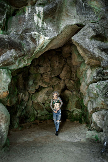 Full length of woman standing in cave