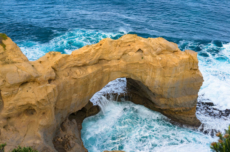Unusual sandstone rock formation in form of arch in the ocean. great ocean road, victoria, australia