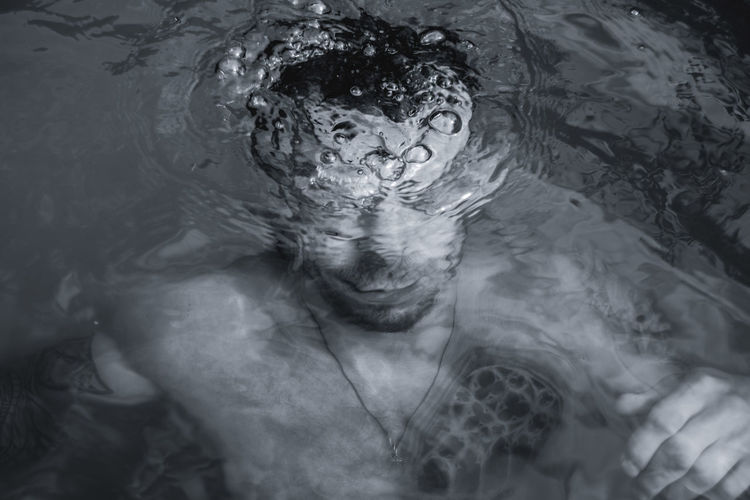 High angle view of young man swimming underwater