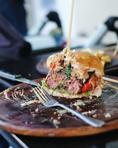 Close-up of burger with fork on table