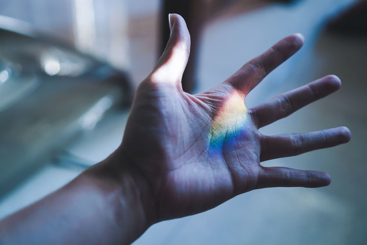 Close-up of human hand with spectrum