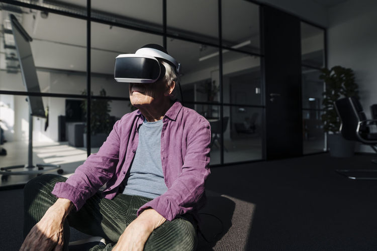 Entrepreneur using virtual reality headset while sitting in office