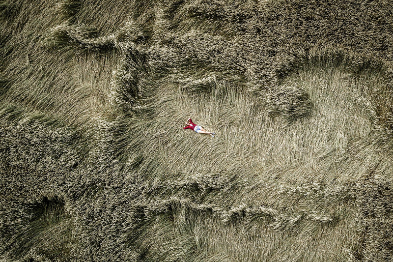 High angle view of woman lying down on field
