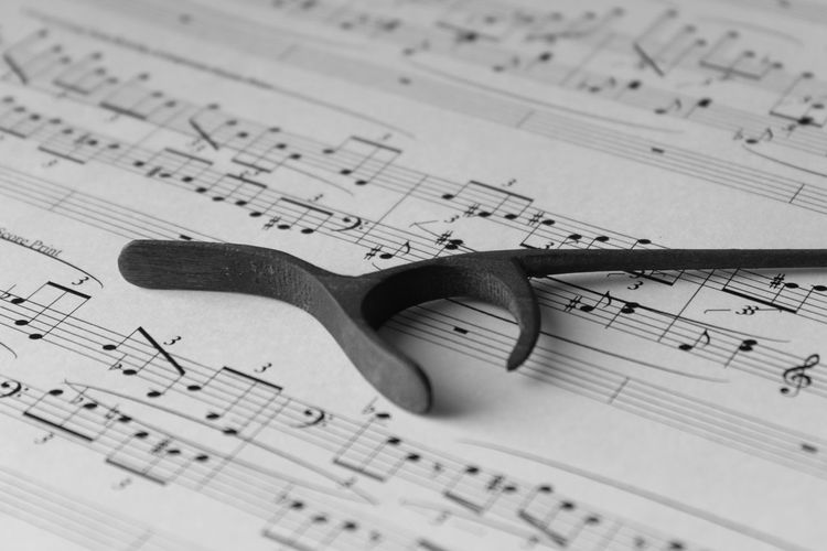 Close-up conductor baton on sheet music