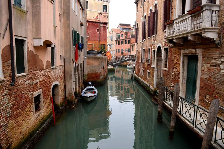 Canal amidst buildings in city