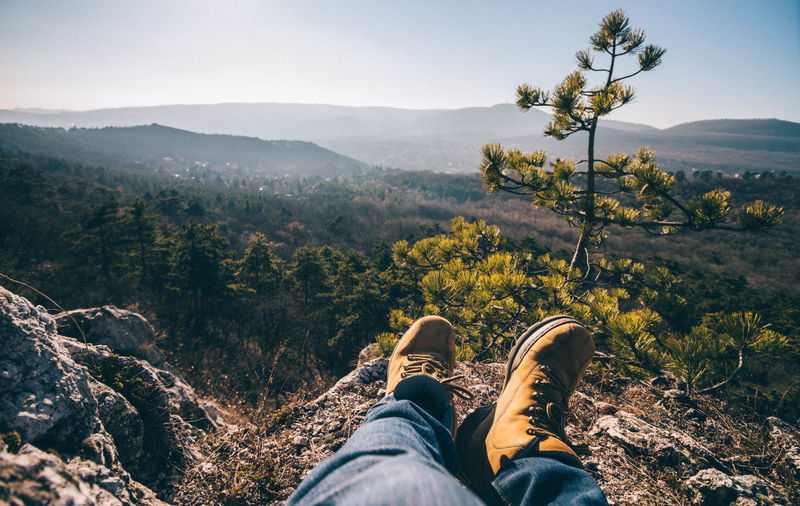 Low section of person relaxing on mountain