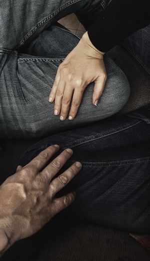 High angle view of couple hands