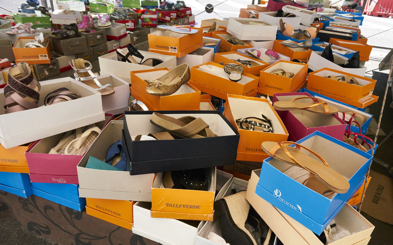 Various sandals in boxes at store