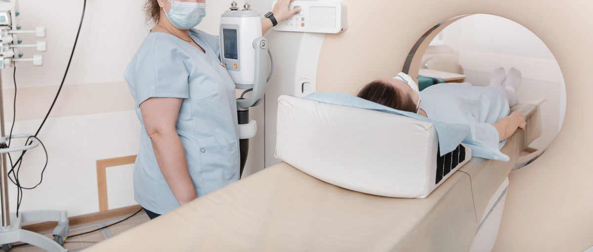Radiotherapist scanning patient in machine