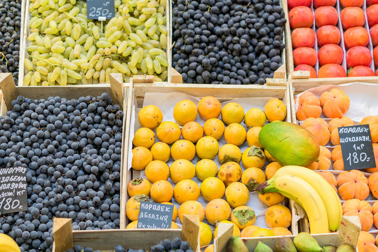 An assortment of ripe fruits in wooden boxes at the russian farmer's market
