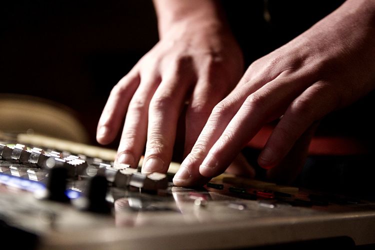 Cropped hands playing sound mixer