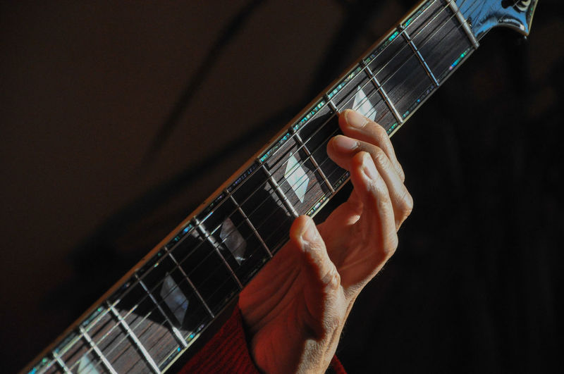 Cropped image of man holding guitar