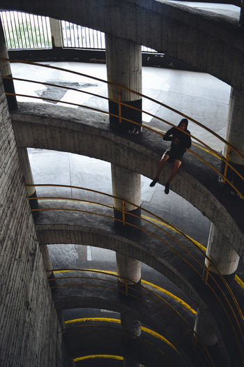 High angle view of man sitting in corridor