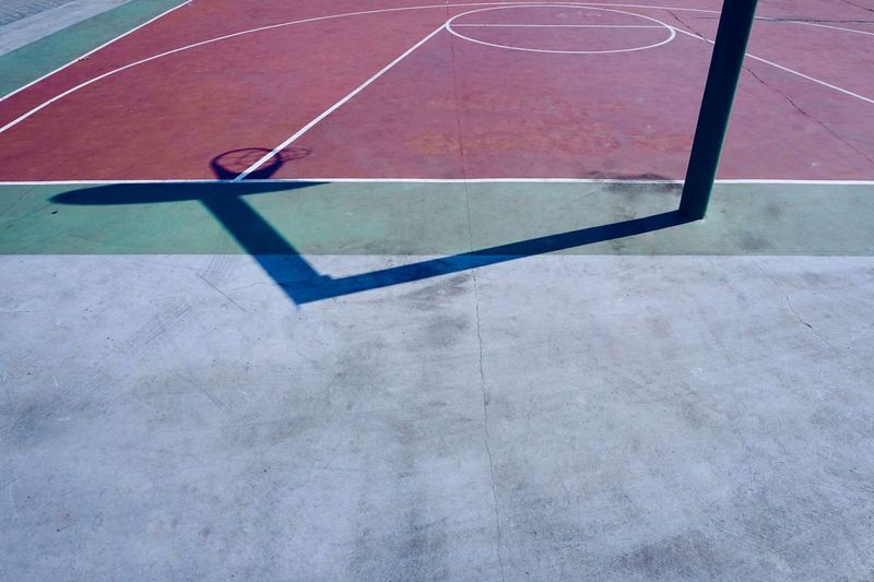 Basketball hoop shadow silhouette on the court on the street