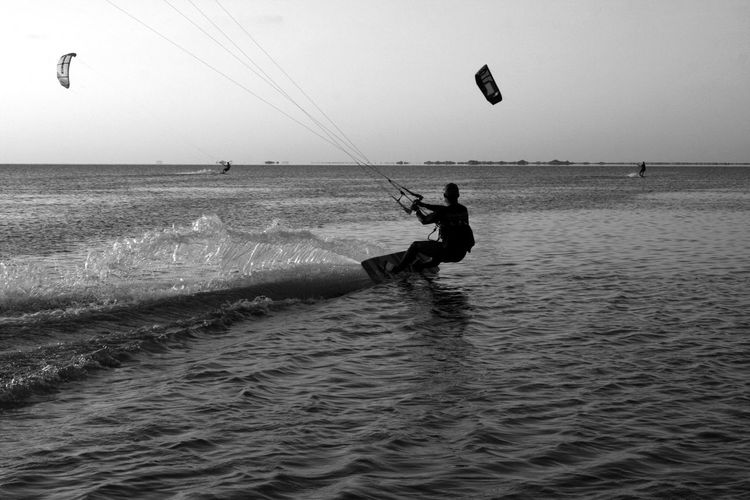 Man surfing in sea against sky in djerba