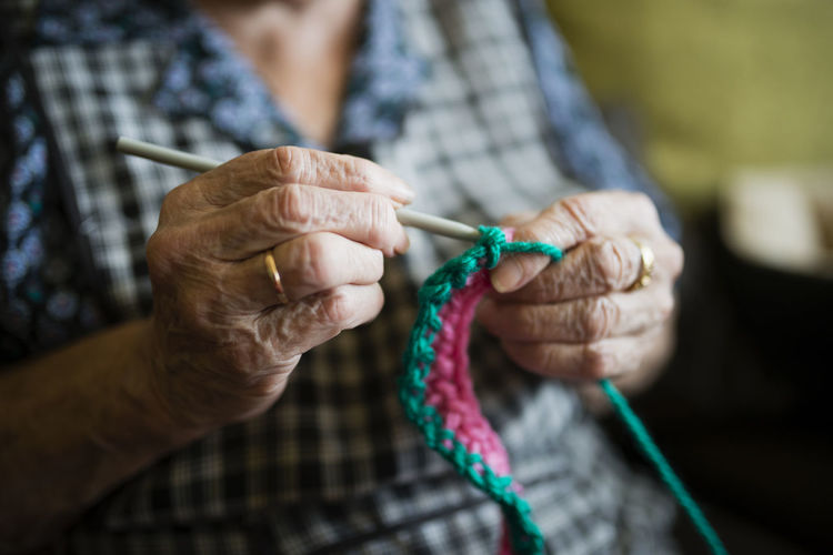 Hands of senior woman crocheting, close-up