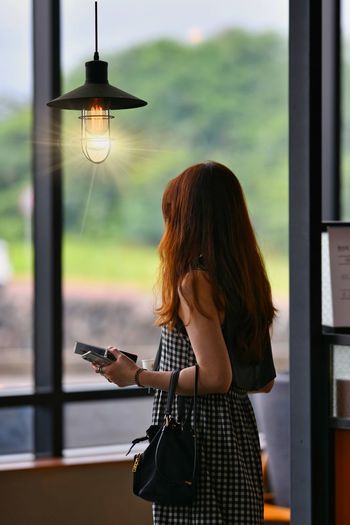 Woman standing on mobile phone