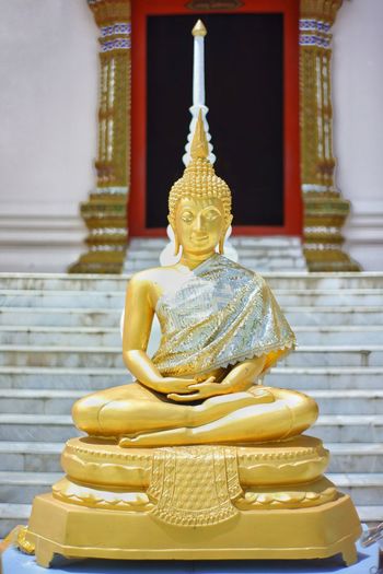 Sculpture of buddha statue in temple outside building