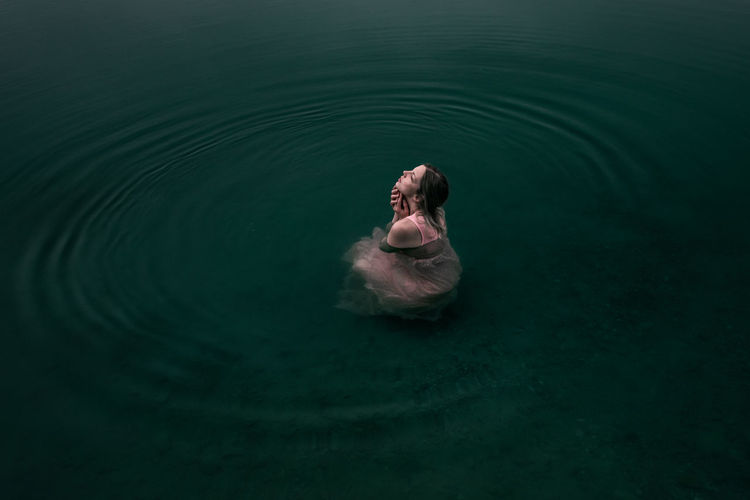 High angle view of woman swimming in lake