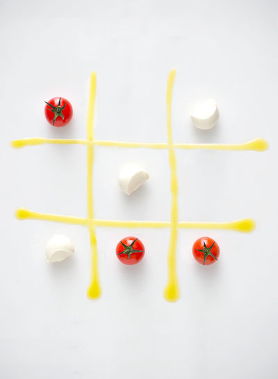 Tomatoes and cheese on tic-tac-toe grid