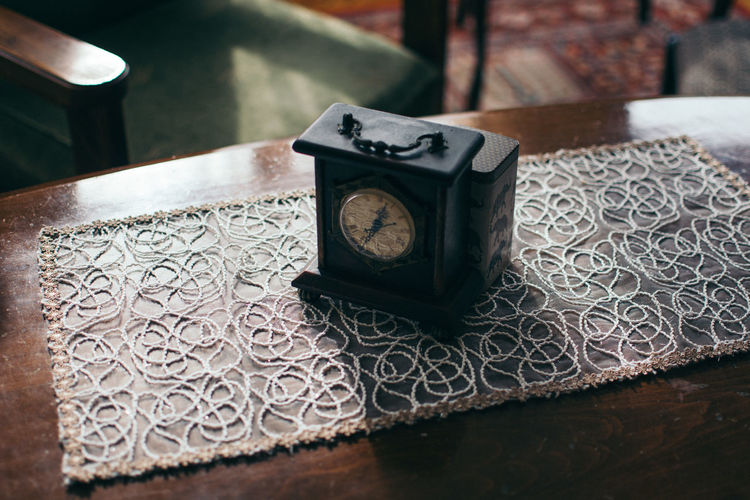 High angle view of vintage clock on table