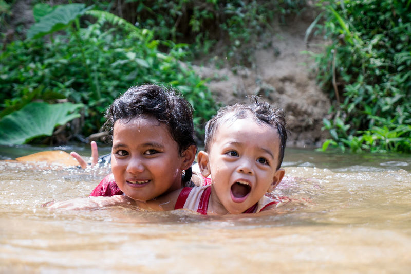 Close-up of children playing in river