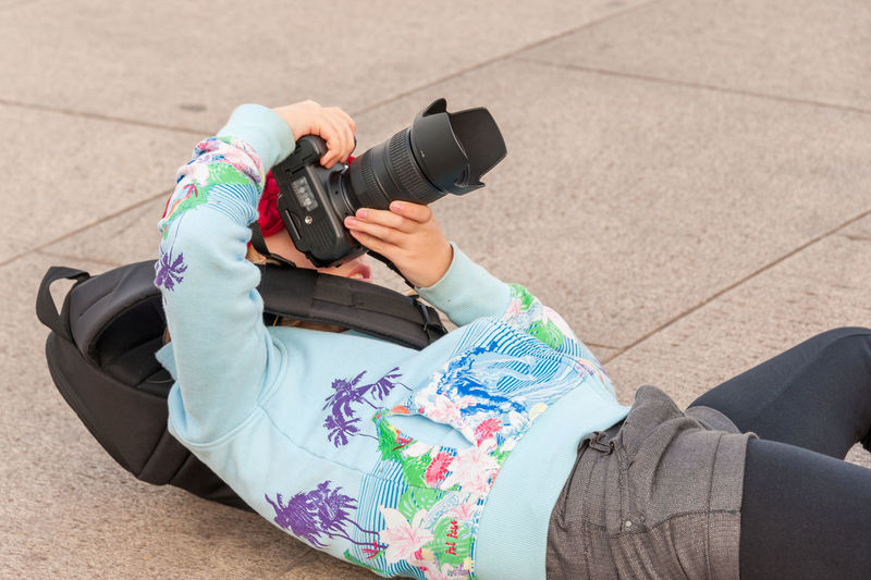 Low section of woman photographing camera