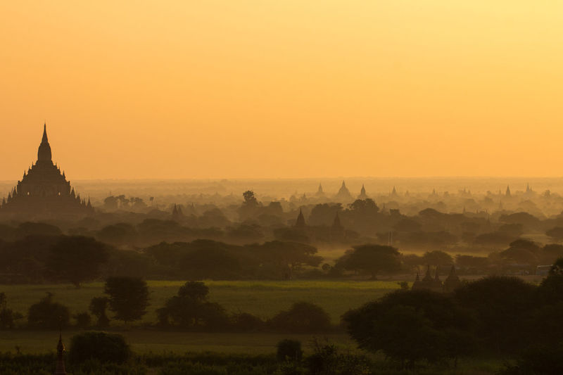 Temples against sky during sunset