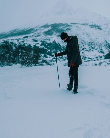 Man standing on snow covered land