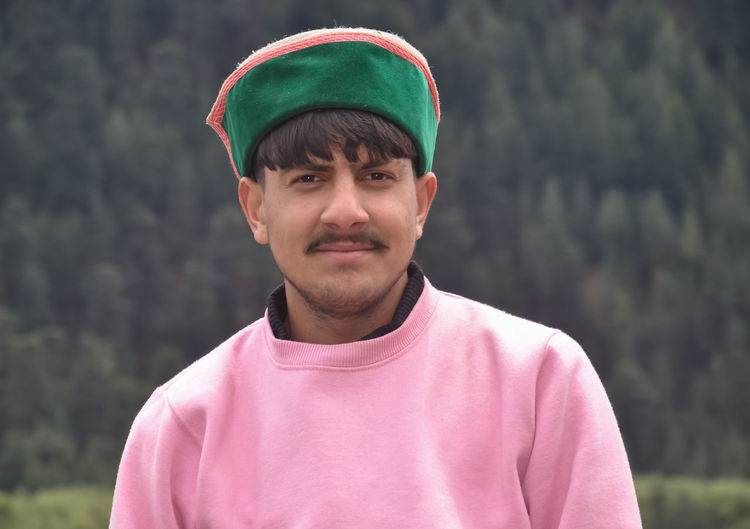 Portrait of young man standing outdoor with wearing himachali topi