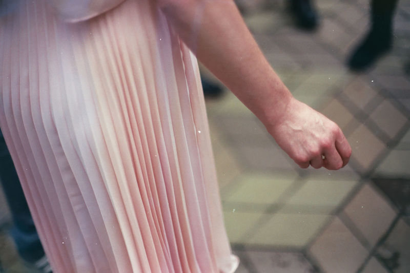Close-up mid section of woman holding hands
