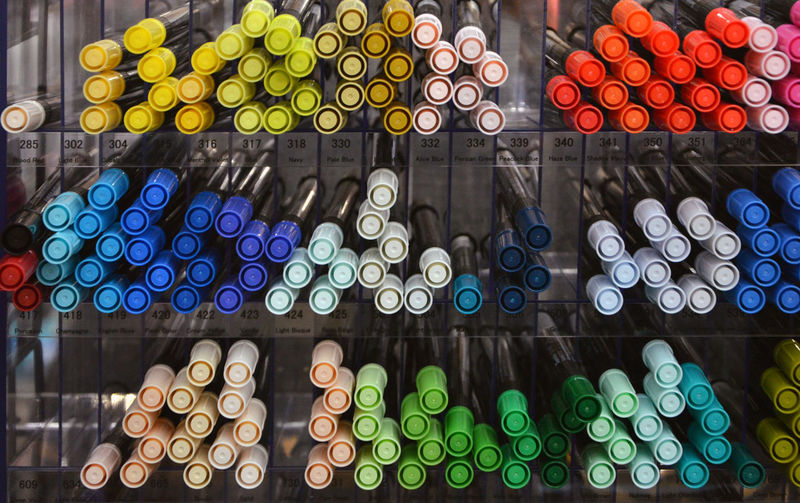 Close-up of multi colored pens for sale in shelves