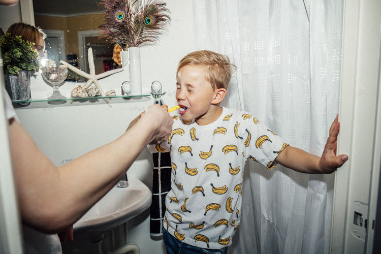 Boy standing in bathroom at home